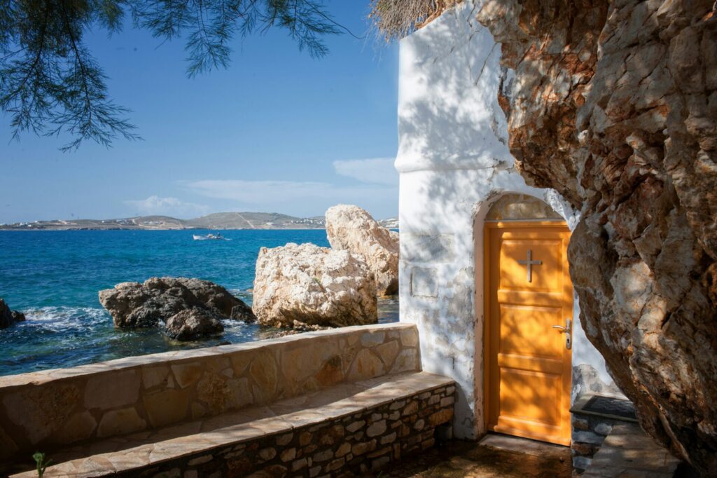 whitewashes building with a yellow door on an island in Greece
